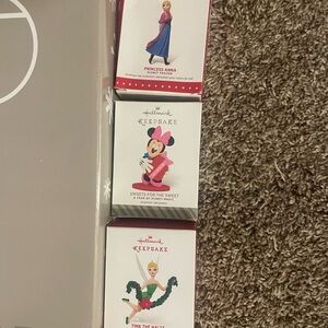 Hallmark Disney ornaments and display stand.  Brand New!